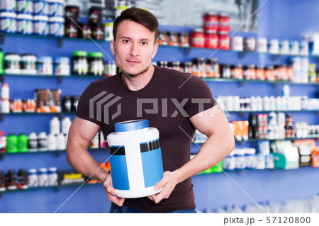 Guy holding sport food supplements 57120800