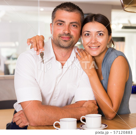 Happy couple in kitchen with keys Happy couple in kitchen with keys 57120883