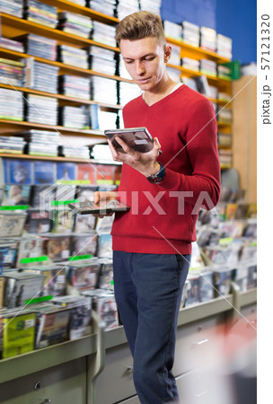 Joyful man looking for interesting movies 57121320