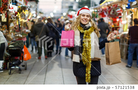 Cheerful girl near Christmas fair shops Cheerful girl near Christmas fair shops 57121538
