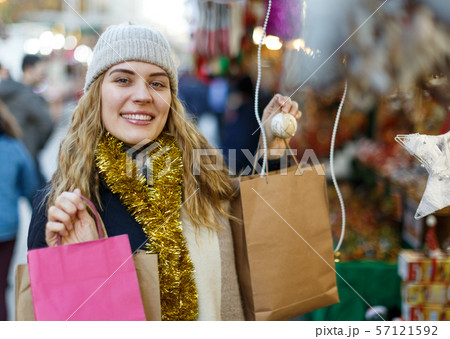 Girl holding paper bags at Christmas fair Girl holding paper bags at Christmas fair 57121592