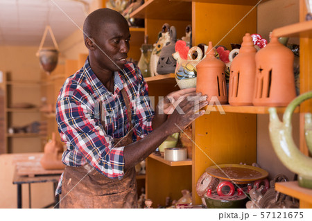 Potter checking clay products 57121675