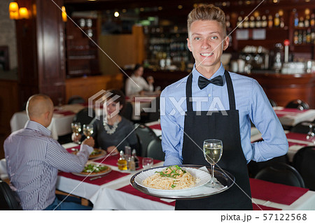 Waiter with tray in restaurant Waiter with tray in restaurant 57122568