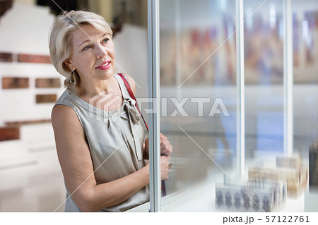 Adult female looking at artwork copper exhibit in the gallery indoors Adult female looking at artwork copper exhibit in the gallery indoors 57122761