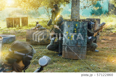 Group of friends paintball players in camouflage playing togeth Group of friends paintball players in camouflage playing togeth 57122860