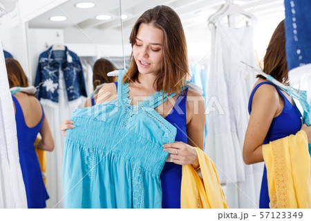 Girl trying new dress in front of mirror Girl trying new dress in front of mirror 57123349
