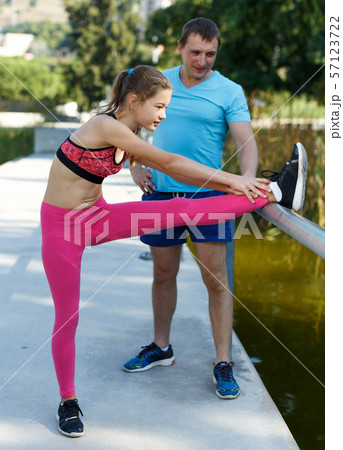 Girl doing exercises with father 57123722