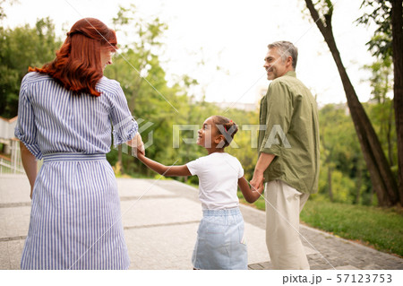 Woman looking at her lovely daughter and handsome husband Woman looking at her lovely daughter and handsome husband 57123753