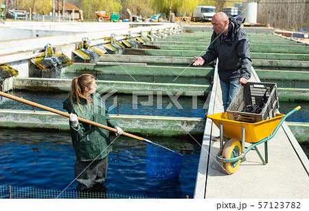 Male and female catching fish from reservoir 57123782