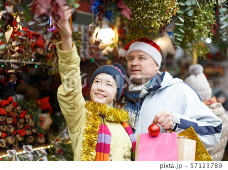 Girl with father shopping on Christmas market 57123789