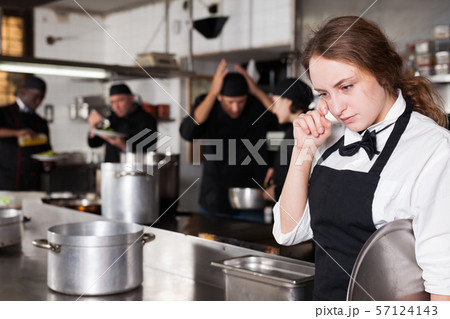 Tired and upset waitress in kitchen of restaurant 57124143