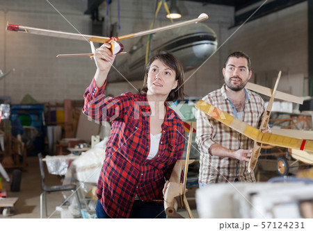 Couple having fun with plane models 57124231