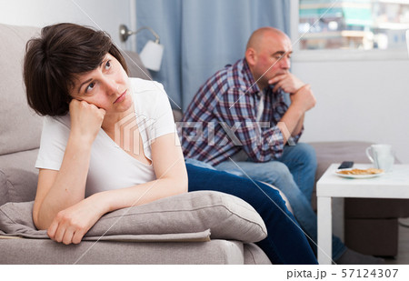 Unhappy mature woman after quarrel, man on background 57124307