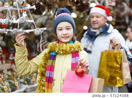Girl looking for Christmas decorations Girl looking for Christmas decorations 57124388