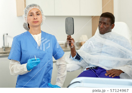 Portrait of cosmetician woman preparing to medicine procedure with man in clinic 57124967