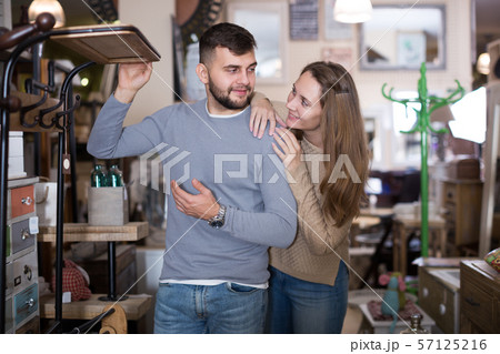Couple looking for hallstand in shop 57125216