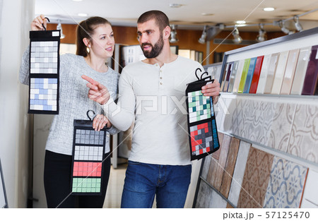 spouses standing with sample of ceramic tile spouses standing with sample of ceramic tile 57125470