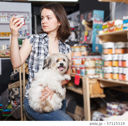 woman with dog buying preserves woman with dog buying preserves 57125519