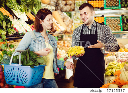 Male seller assisting in buying 57125537