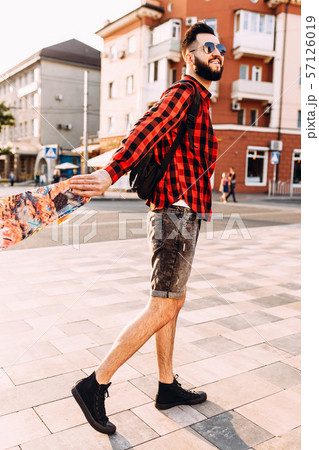 guy with a beard in sunglasses, walks with a 57126019