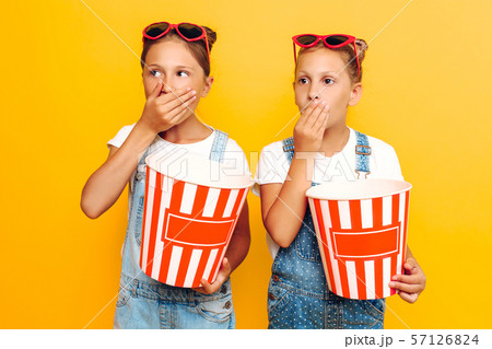 Two teenage girls, girlfriends with popcorn in Two teenage girls, girlfriends with popcorn in 57126824