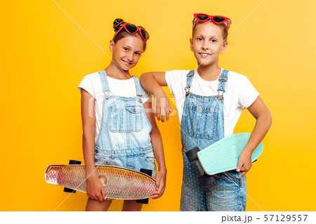Two teenagers, stylish children posing with Two teenagers, stylish children posing with 57129557