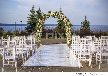 Outdoor wedding ceremony place with wedding arch 57129929