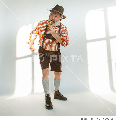 Portrait of Oktoberfest man, wearing the traditional Bavarian clothes Portrait of Oktoberfest man, wearing the traditional Bavarian clothes 57130318