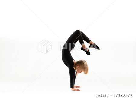 Female little gymnast practicing isolated on white background Female little gymnast practicing isolated on white background 57132272