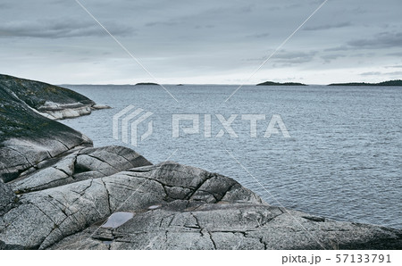 Rocky sea shore on an overcast day background  57133791