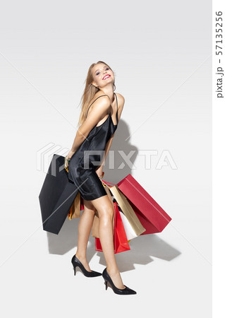 Young woman in dress shopping on white background Young woman in dress shopping on white background 57135256