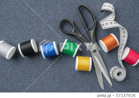 Scissors, measuring tape, multicolored threads. Scissors, measuring tape, multicolored threads. 57137016