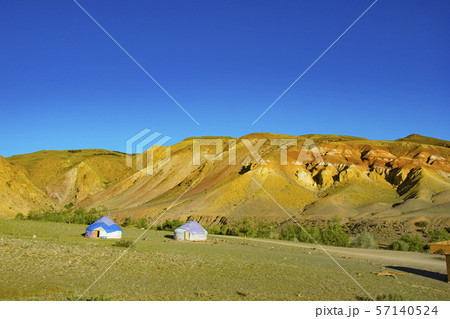 Yurta is set against the background of multi-colored mountains Yurta is set against the background of multi-colored mountains 57140524