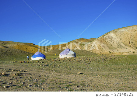 Yurta is set against the background of multi-colored mountains Yurta is set against the background of multi-colored mountains 57140525