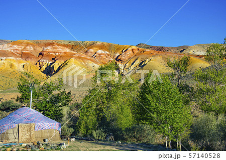 Yurta is set against the background of multi-colored mountains Yurta is set against the background of multi-colored mountains 57140528