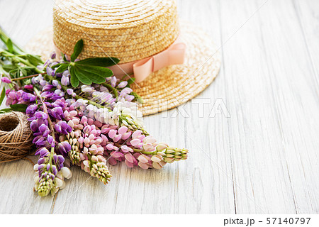 Straw hat and lupine flowers Straw hat and lupine flowers 57140797