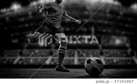 Football player with ball on field of stadium 57141007