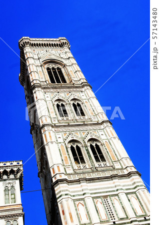Europe, Italy, Florence, Giotto's Campanile. Tall clock tower next to the city dome with blue sky 57143480