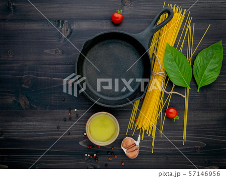 The thin spaghetti on black wooden background. The thin spaghetti on black wooden background. 57146956