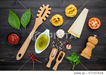 The  pasta on black wooden background. Yellow 57147416