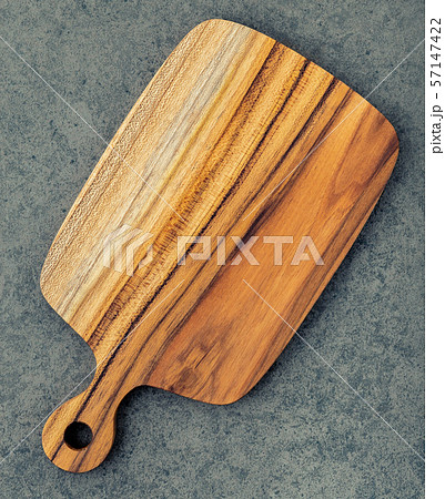 Chopping teak wood cutting board on dark stone 57147422