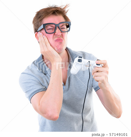 Funny young nerd man with big eyeglasses playing games and losing Funny young nerd man with big eyeglasses playing games and losing 57149101