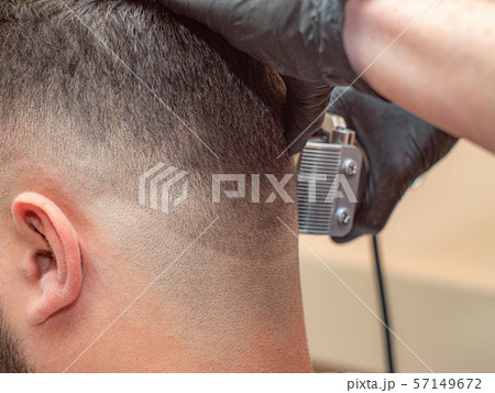 Hairstylist working with clipper, males nape and Hairstylist working with clipper, males nape and 57149672