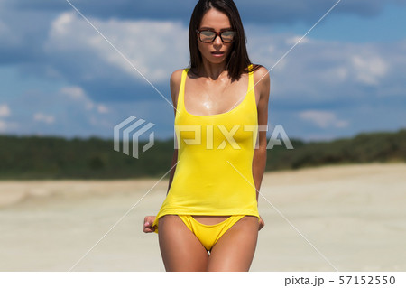 Beautiful woman in swimsuit on beach Beautiful woman in swimsuit on beach 57152550