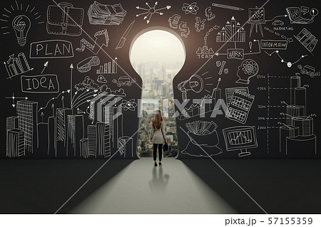 Rear view of a businesswoman against black wall with keyhole 57155359