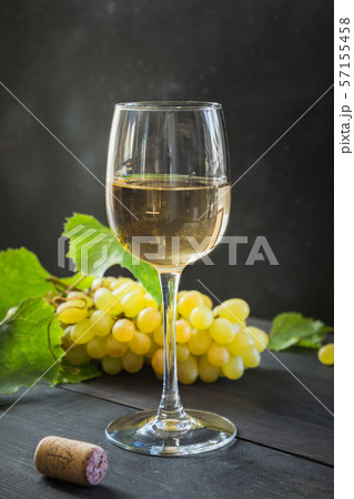 Bottle of white wine with wineglass, ripe grape. Bottle of white wine with wineglass, ripe grape. 57155458