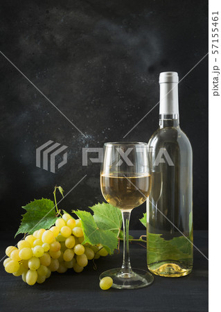 Bottle of white wine with wineglass, ripe grape. Bottle of white wine with wineglass, ripe grape. 57155461