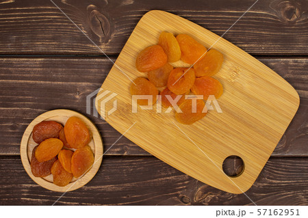 Dried orange apricot on brown wood 57162951