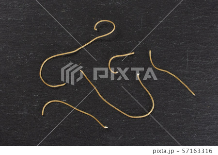 Raw thin noodles on grey stone 57163316