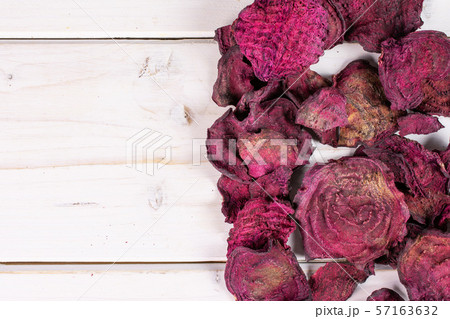Dried red beetroot on grey wood 57163632